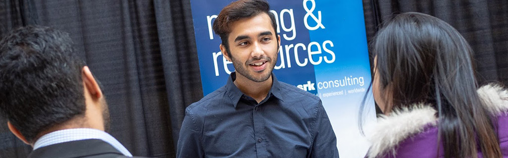 Students inquiring at career booth