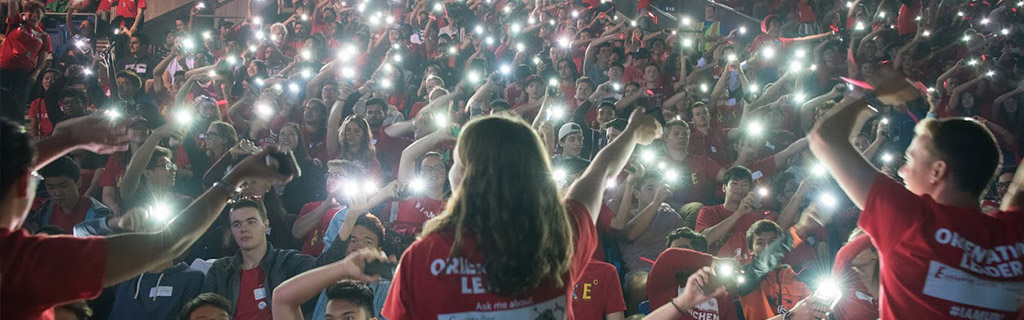 Students waving lights in crowd