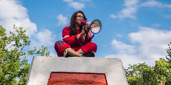 EUS exec sitting on top of the Cairn on a sunny day