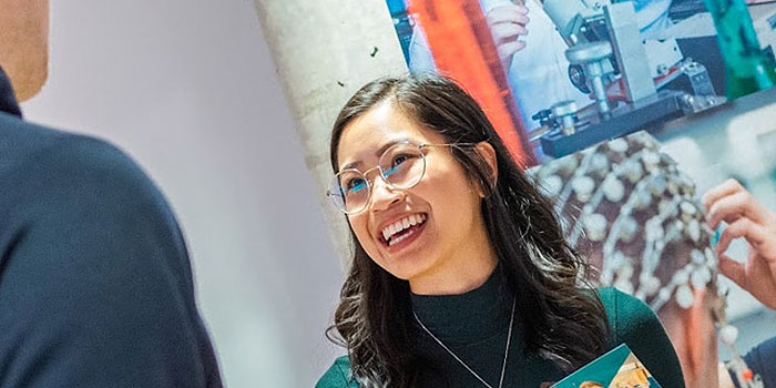 Advisor talking to a student at an information booth