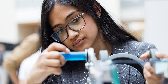 Female student preparing her team project at Design and Innovation Day