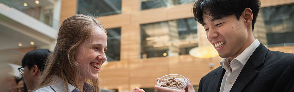 Two people smiling and talking