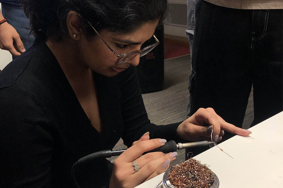 Close up of UBC student working on an electrical project