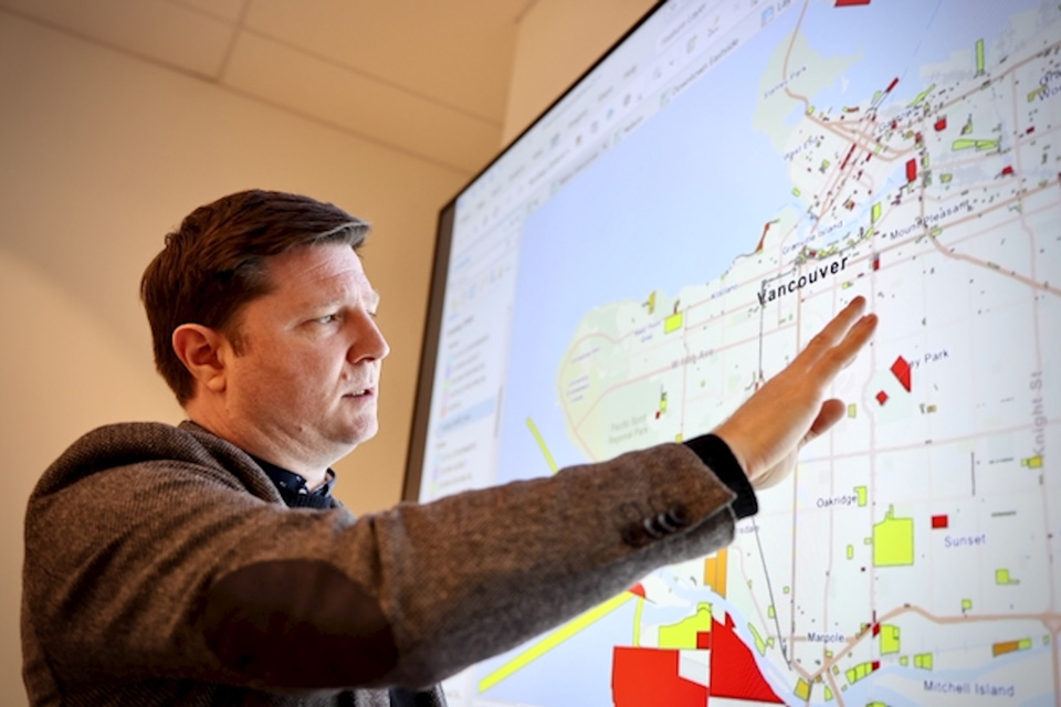 Craig Jones points to a digital map of Vancouver