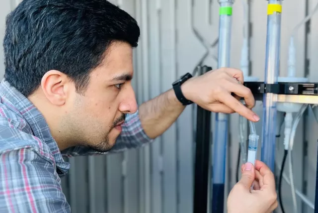 Dr. Madjid Mohseni doing experiments with tubes