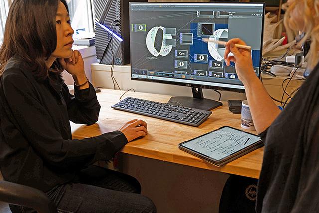 Dr. Megan Smith and sessional lecturer Gao Yujie discuss their work on an installation in UBC Okanagan's Faculty of Creative and Critical Studies.