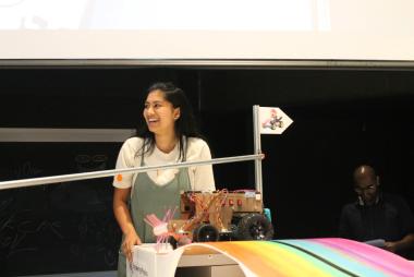 Girl laughs with robot.