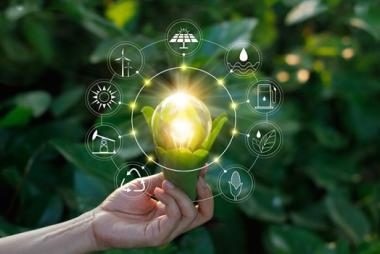 Hand holding a lightbulb within leaves, surrounded by circular economy icons