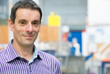 A head shot of Dr. Bernard Laval. The background is an out-of-focus lab.