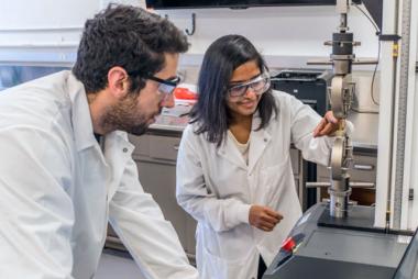 Two students doing work in an engineering lab