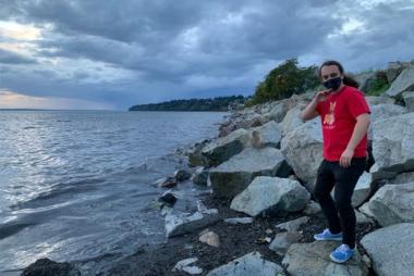 UBC Biomedical Engineering Ph.D. student Kieran Morton poses in front of the camera. They are situated to the right next to the ocean.
