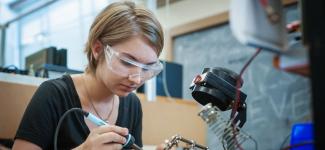 Electrical engineering student working on her circuit board