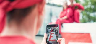 Engineering students taking a photo with the Cairn