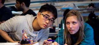 Two UBC mechanical engineering students prepare for the autonomous landing platform competition.