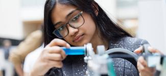A female student demonstrating her project at Design and Innovation Day