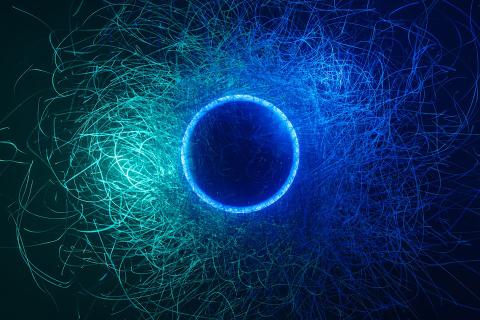 Abstract image of blue circle with green and blue lines swirling out of it