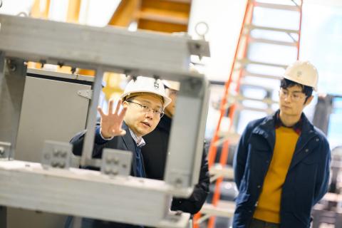 Tony Yang shows a student a structure in his lab