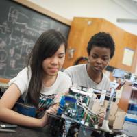 Two UBC Engineering Physics students preparing for the annual summer robot competition.